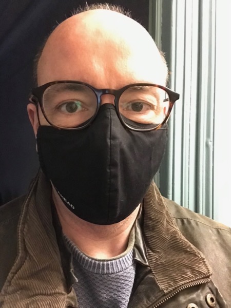 A balding man (the author) wearing a COVID-19-type facemask and glasses.